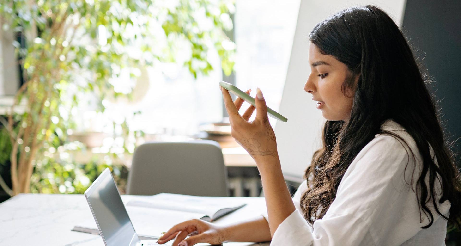 Small-business owner on a phone call while working at her laptop